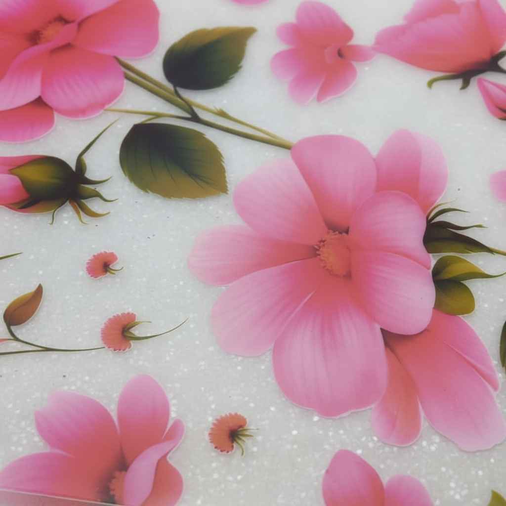 Close-up of pink flowers with green leaves on a textured white background